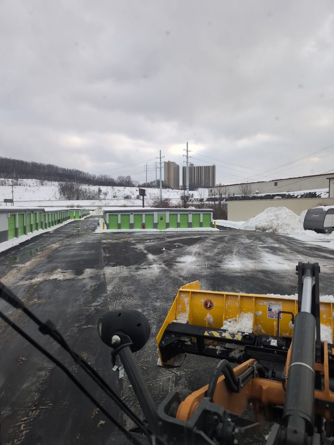 Cleared commercial lot seen from the loader cab