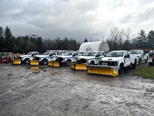 J and R plow trucks lined up and staged before a storm