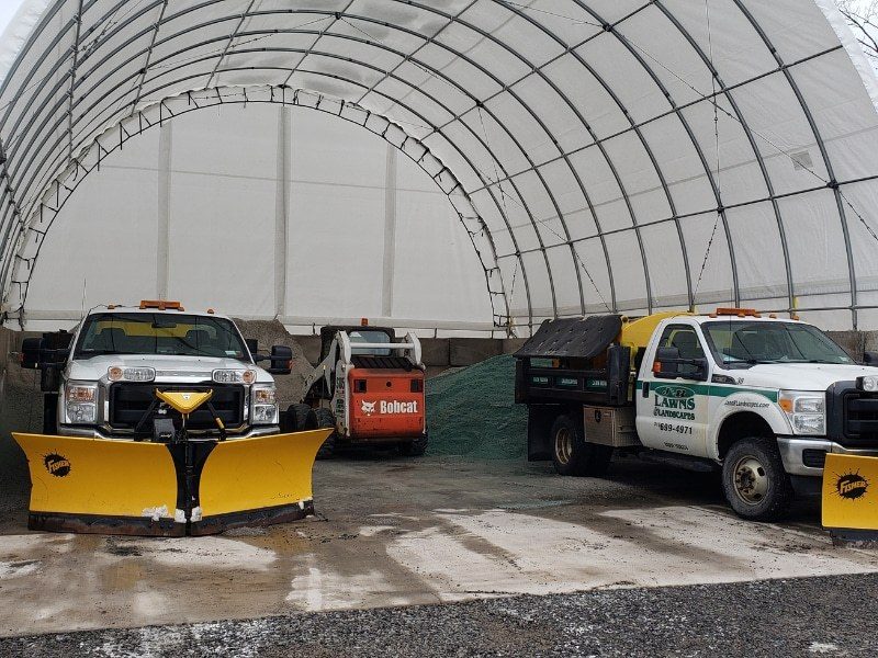 Plow trucks and bulk salt staged in the equipment building